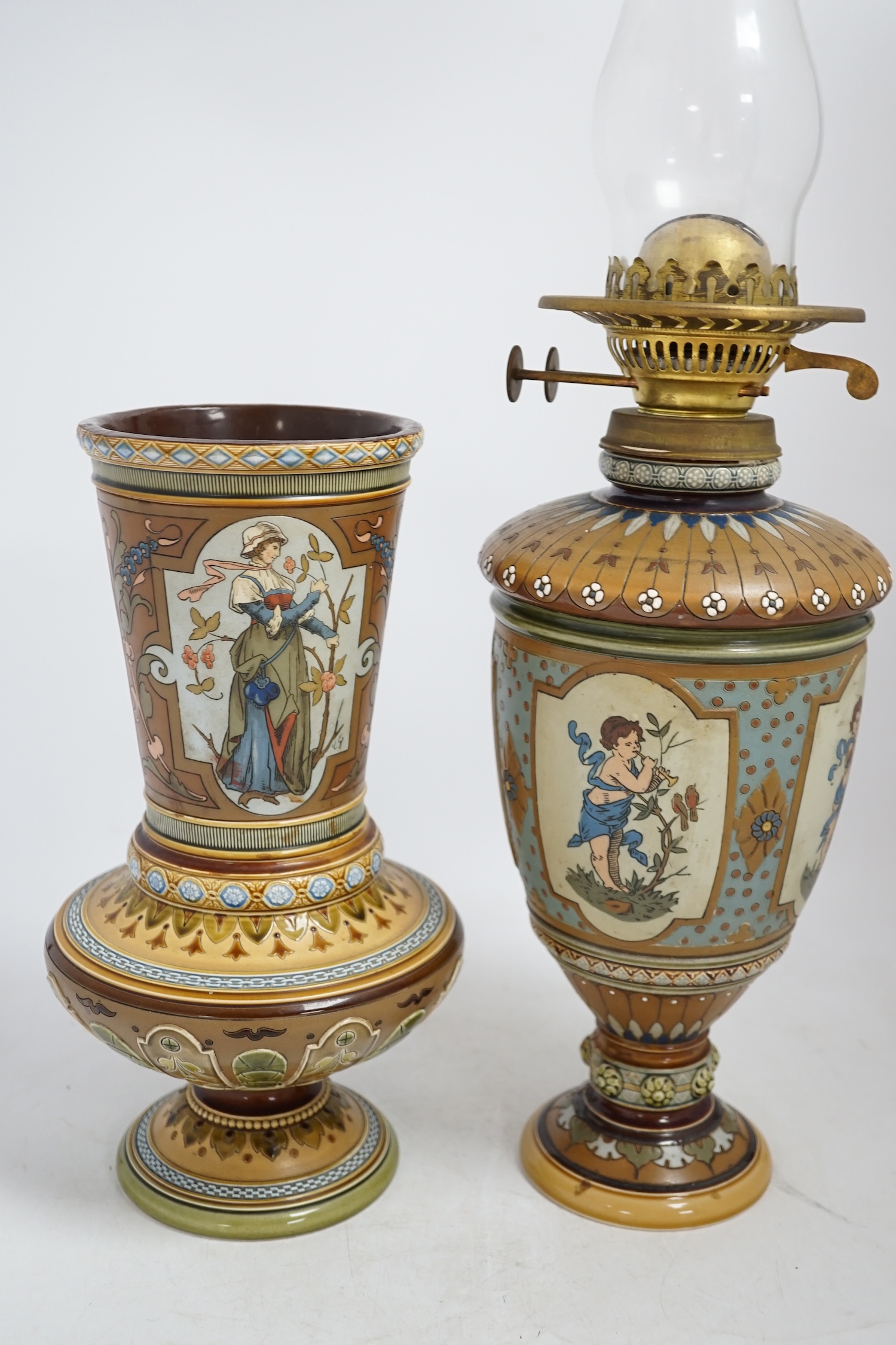 A Mettlach stoneware oil lamp and a similar Mettlach vase, largest 58cm high. Condition - good